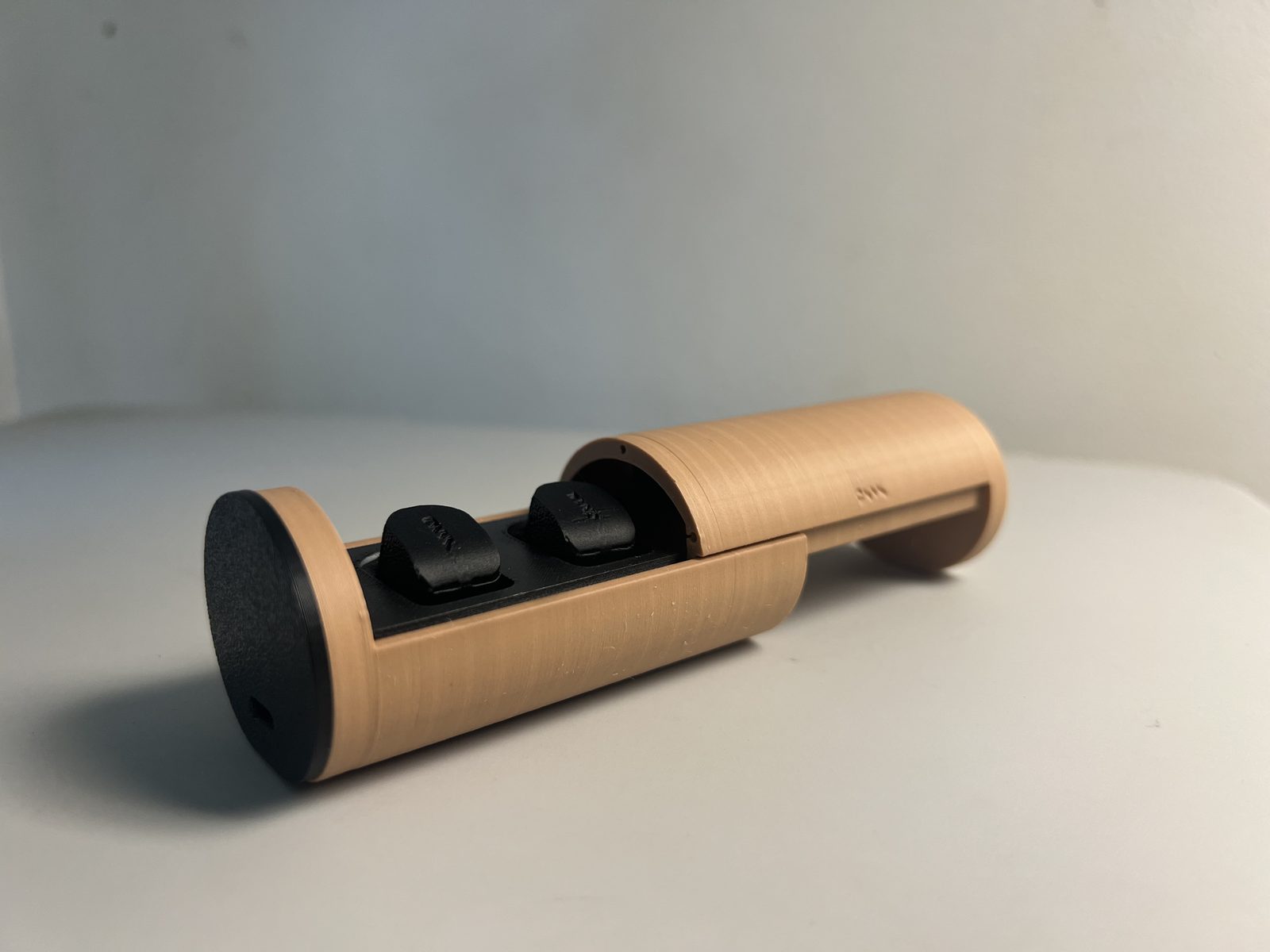 Third ONYX prototype: the 3D printed case with its cover slid open to show the earbuds